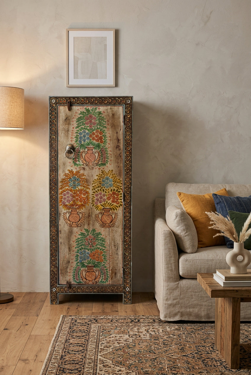 A rustic wooden cabinet featuring hand-painted floral motifs in terracotta and green on a weathered brown background, with an ornate dark border and a metal knob.