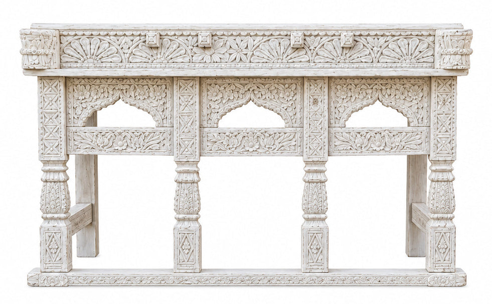 A handcrafted teak wood console table with intricate carvings, featuring a beige and white color palette.